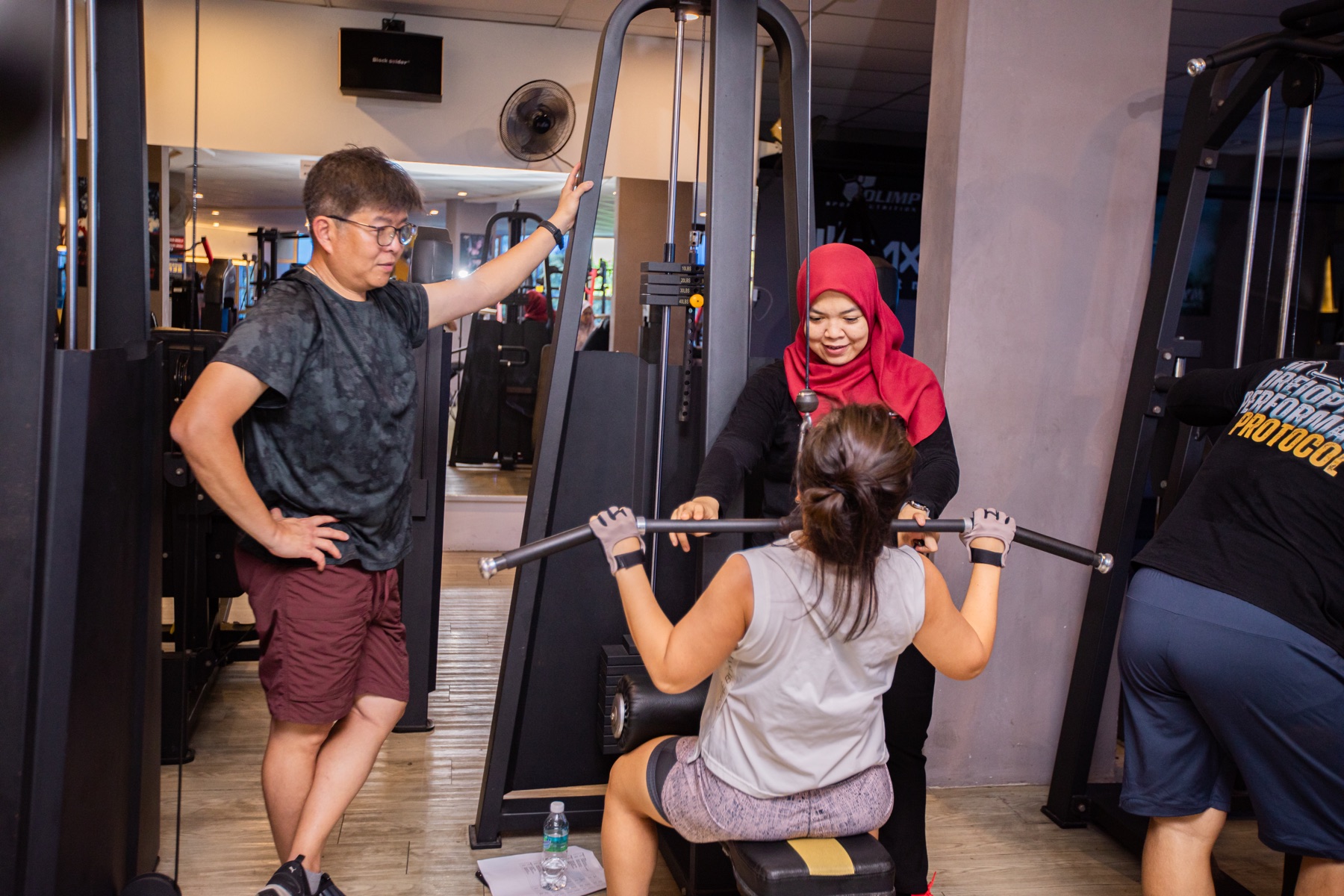 Coach Ho coaching a member during a strength-training session.
