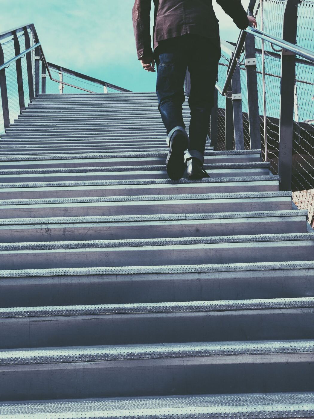 A person climbing stairs one step at a time